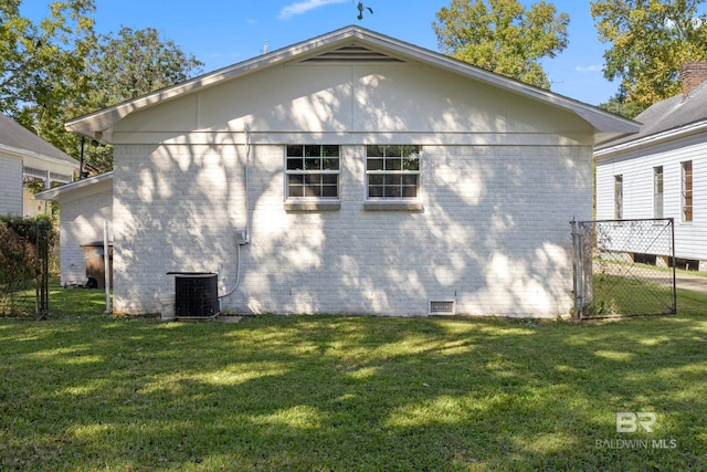 view of property exterior featuring central air condition unit and a yard