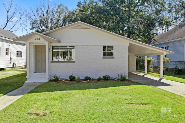 view of front of house with a front lawn and a carport