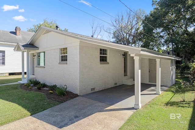 view of home's exterior with a lawn and a carport