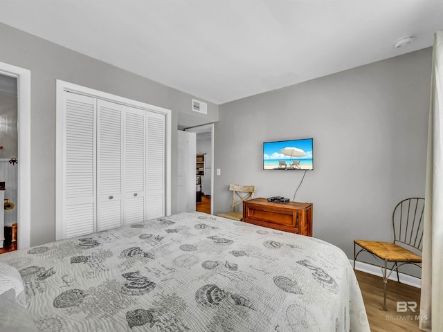 bedroom with a closet and hardwood / wood-style flooring