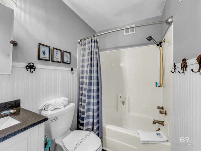 full bathroom featuring vanity, shower / bath combination with curtain, and toilet