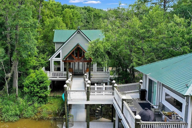 42168 Bayou Rd, Bay Minette, AL 36507 - rear view of house featuring stairway, a metal roof, a wooded view, and a deck with water view