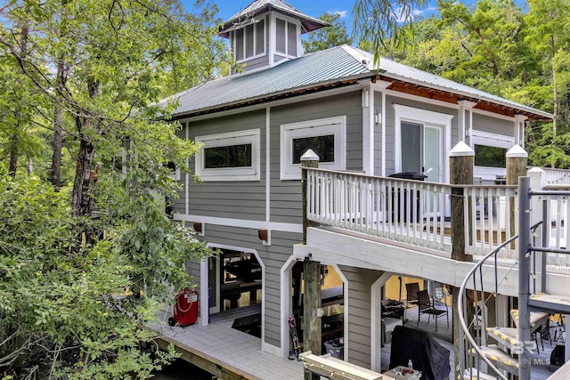 42168 Bayou Rd, Bay Minette, AL 36507 - back of house featuring a wooden deck and a metal roof