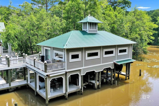 42168 Bayou Rd, Bay Minette, AL 36507 - back of property featuring a metal roof, view of scattered trees, and a deck with water view