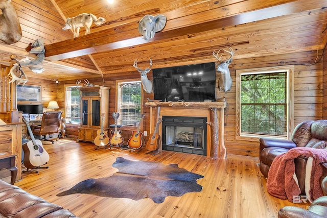 42168 Bayou Rd, Bay Minette, AL 36507 - living area with wood walls, hardwood / wood-style flooring, a fireplace, a wood ceiling with exposed beams, and plenty of natural light