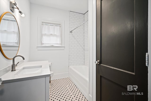 full bathroom with vanity, toilet, and tiled shower / bath combo