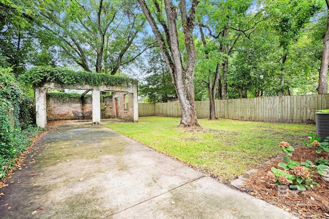 view of yard with cooling unit and a patio area