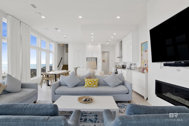 tiled living room with a water view
