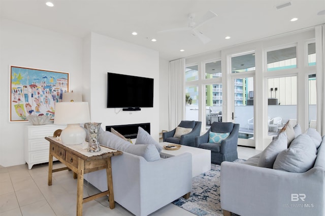 tiled living room with ceiling fan