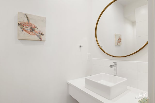 bathroom with tasteful backsplash and sink