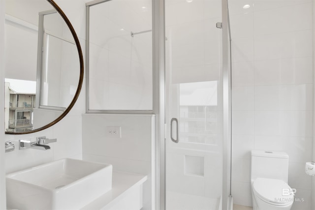 bathroom featuring tile walls, sink, toilet, and walk in shower