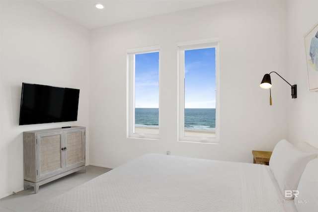 tiled bedroom featuring a water view