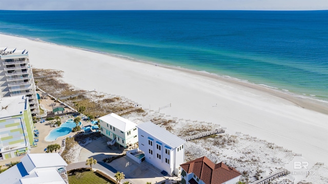 bird's eye view with a water view and a beach view