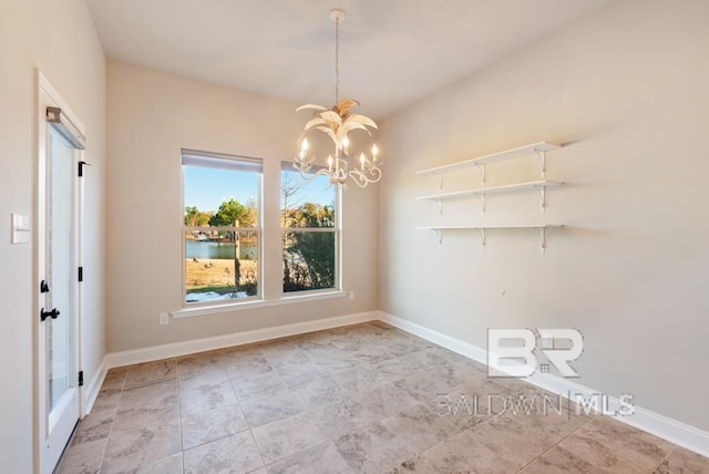 unfurnished dining area with a water view and a chandelier