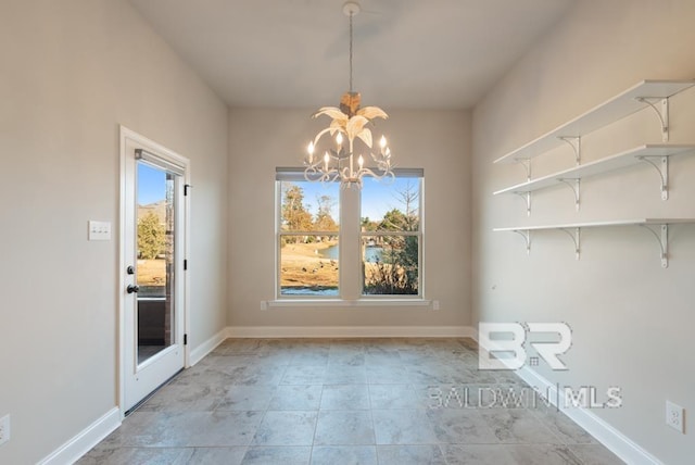 unfurnished dining area with baseboards and an inviting chandelier