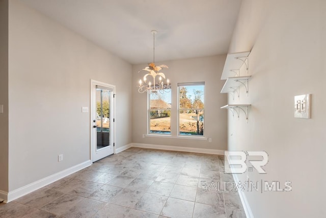 unfurnished dining area featuring a chandelier