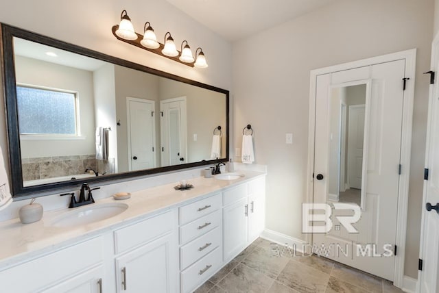 bathroom featuring vanity and a tub to relax in