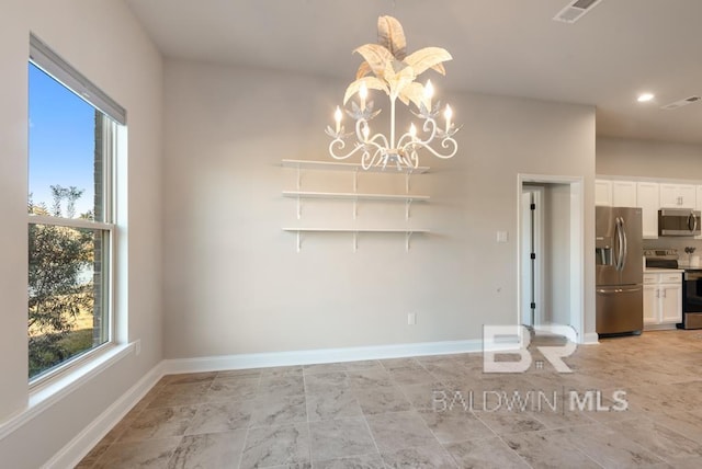 unfurnished dining area featuring an inviting chandelier