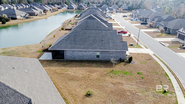 drone / aerial view with a water view and a residential view