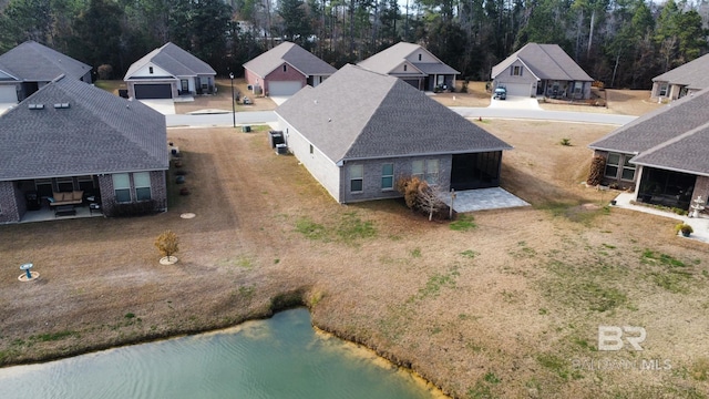 birds eye view of property with a water view