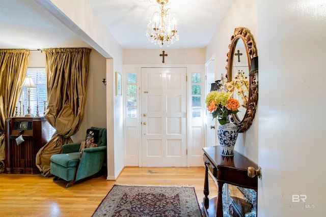 entrance foyer featuring hardwood / wood-style flooring and an inviting chandelier