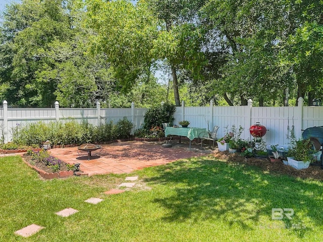 view of yard featuring a patio and an outdoor fire pit