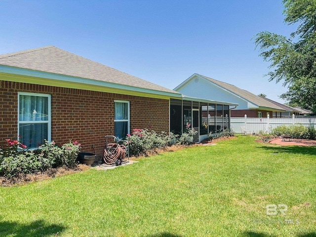 back of house featuring a sunroom and a yard