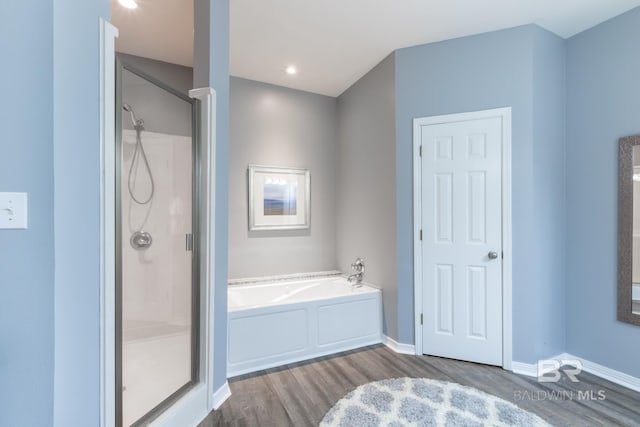 bathroom with plus walk in shower and hardwood / wood-style floors