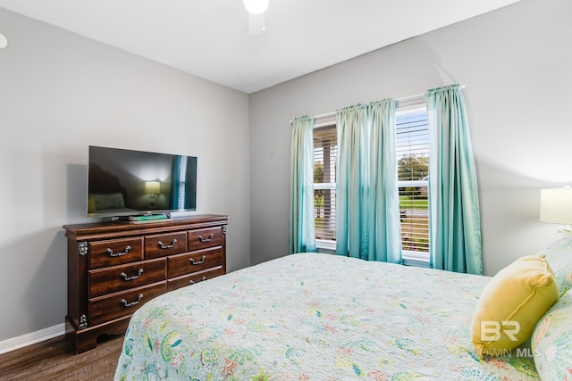 bedroom with ceiling fan and dark wood-type flooring