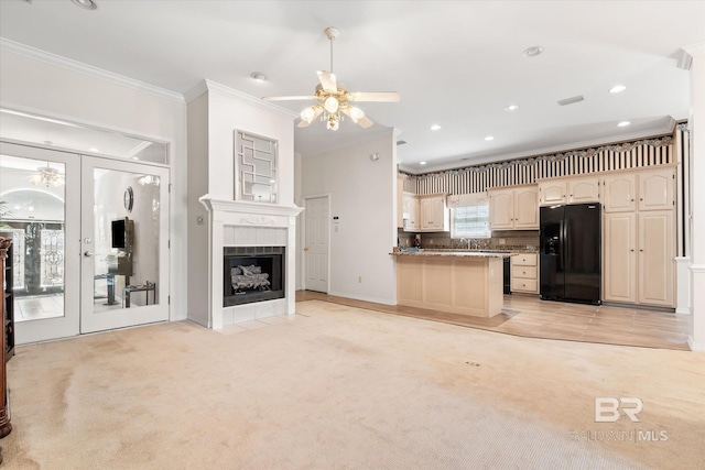 kitchen with french doors, light carpet, black fridge with ice dispenser, and crown molding