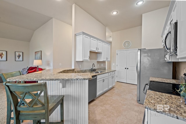 14766 Sonoma Blvd, Silverhill, AL 36576 - kitchen with a sink, white cabinetry, light stone countertops, a peninsula, and stainless steel appliances