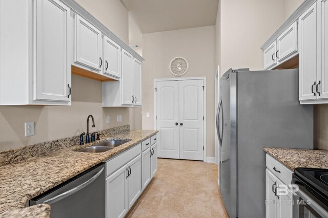 14766 Sonoma Blvd, Silverhill, AL 36576 - kitchen featuring white cabinetry, light stone countertops, a sink, and appliances with stainless steel finishes