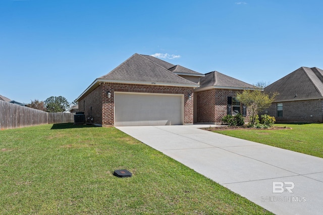 14766 Sonoma Blvd, Silverhill, AL 36576 - view of front of property featuring fence, an attached garage, driveway, a front lawn, and brick siding