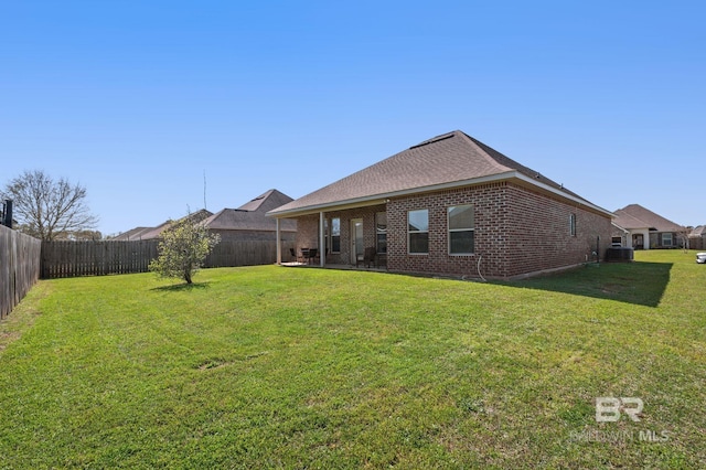 14766 Sonoma Blvd, Silverhill, AL 36576 - rear view of house with brick siding, a fenced backyard, and a yard