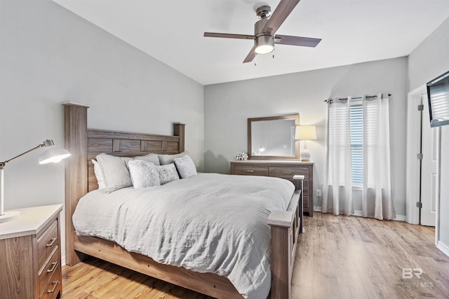 bedroom with light hardwood / wood-style floors and ceiling fan