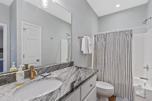 full bathroom with vanity, toilet, and  shower combination