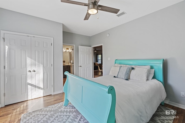 bedroom with hardwood / wood-style floors, ceiling fan, and ensuite bathroom