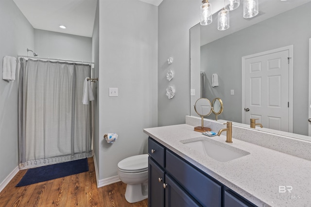 bathroom with hardwood / wood-style flooring, vanity, toilet, and a shower with shower curtain