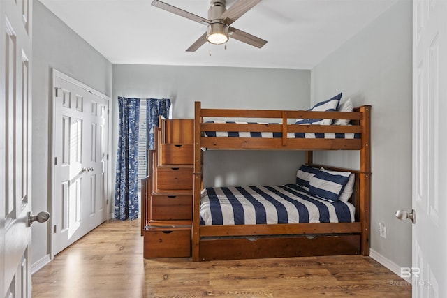 bedroom with light hardwood / wood-style floors and ceiling fan