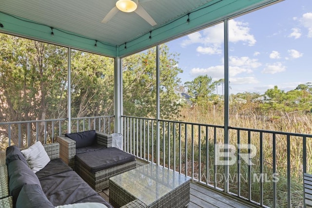 unfurnished sunroom featuring ceiling fan