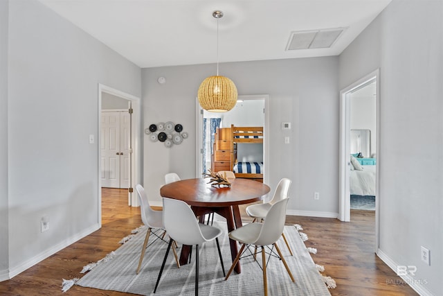 dining room with wood-type flooring