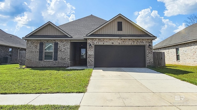 view of front of house featuring central AC unit, a garage, and a front lawn