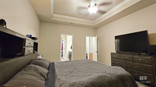 bedroom featuring ceiling fan, a tray ceiling, and crown molding