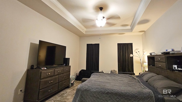 bedroom featuring a tray ceiling, ceiling fan, and crown molding