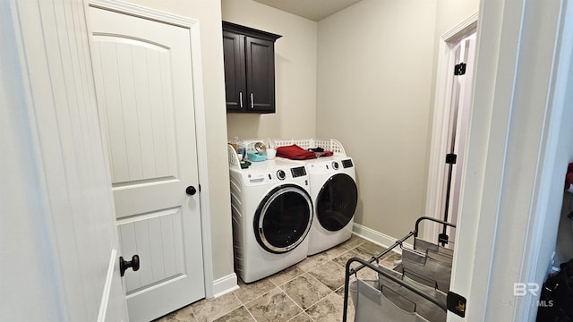 laundry area featuring separate washer and dryer and cabinets