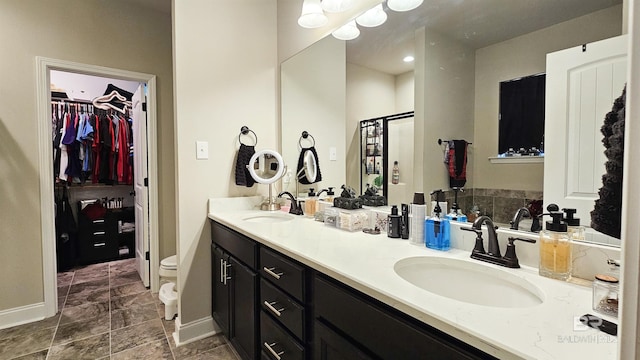 bathroom with an enclosed shower, vanity, and toilet