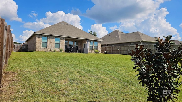 back of house with a yard