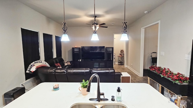 living room featuring ceiling fan and sink