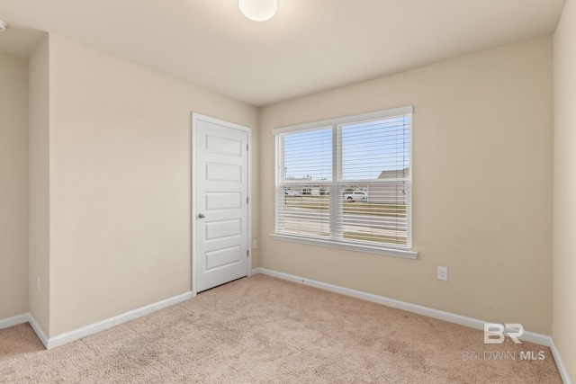 unfurnished room with light carpet