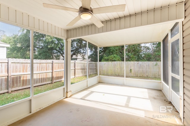 unfurnished sunroom with ceiling fan